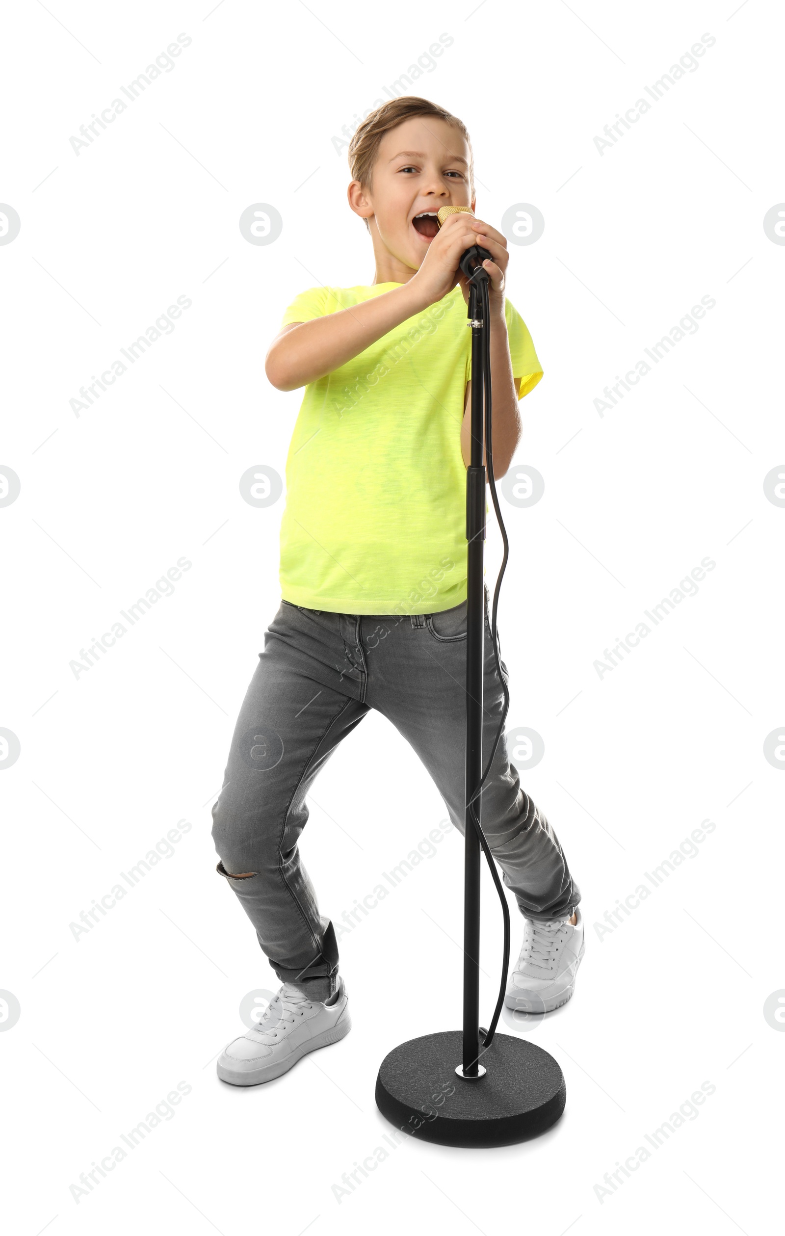 Photo of Cute boy singing in microphone on white background