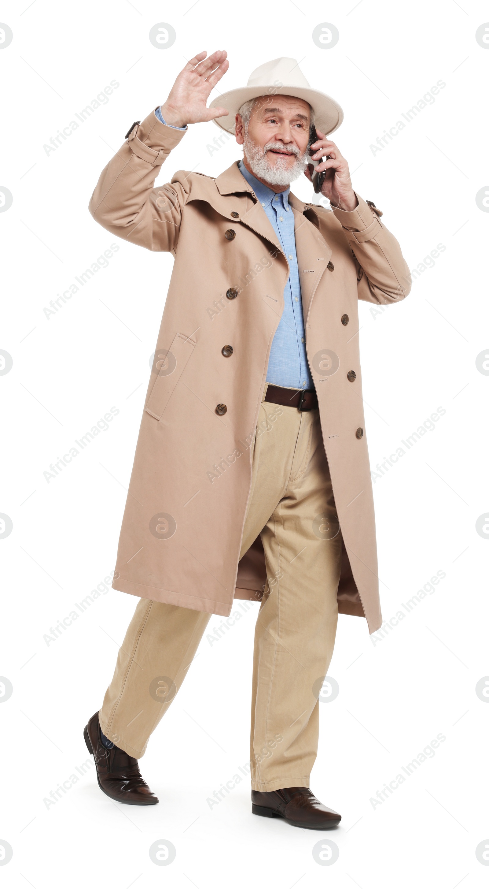 Photo of Senior man talking on smartphone against white background
