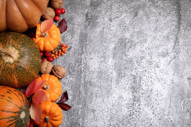 Photo of Flat lay composition with pumpkins and autumn leaves on grey table, space for text. Thanksgiving Day