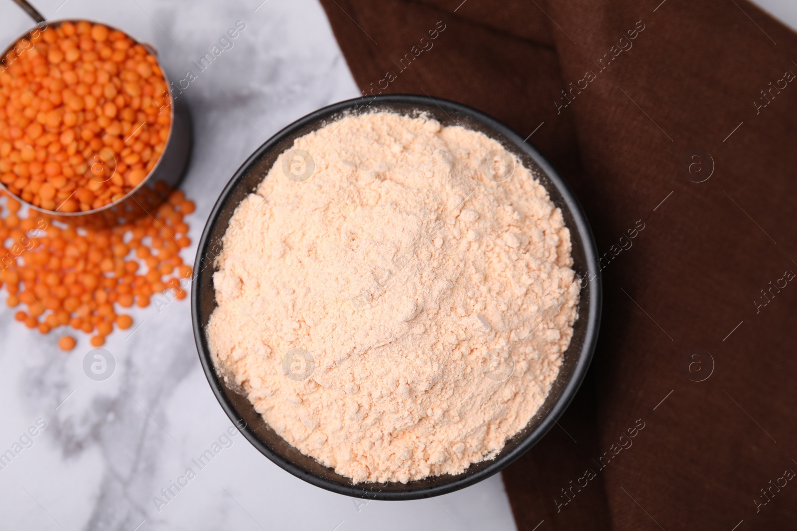 Photo of Lentil flour and seeds on white marble table, flat lay