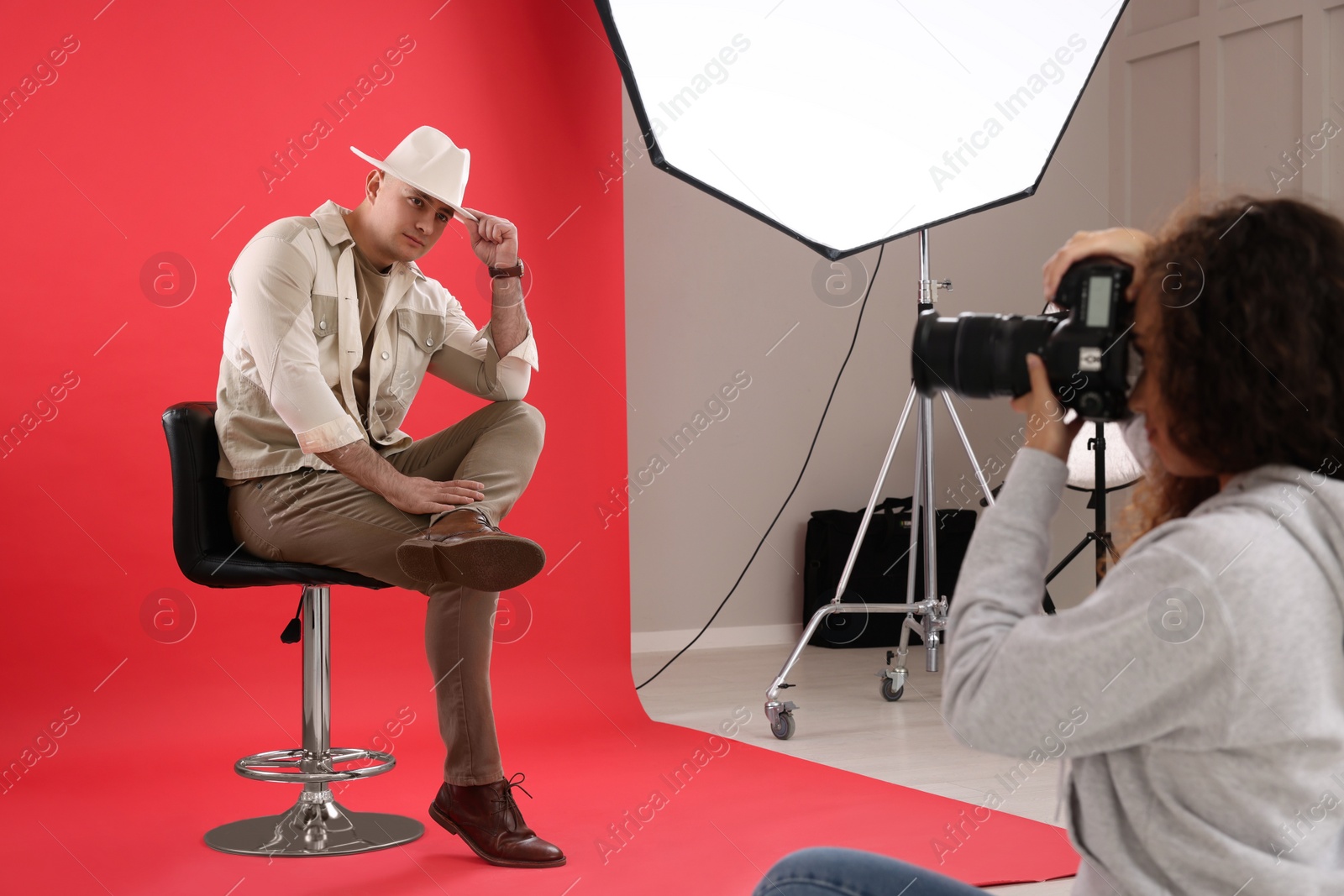 Photo of Handsome model posing for professional photographer in studio