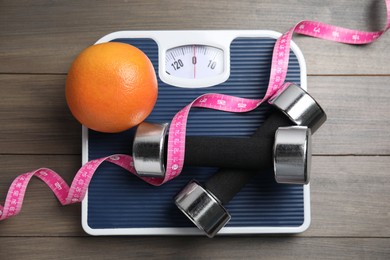 Photo of Flat lay composition with scales on wooden table
