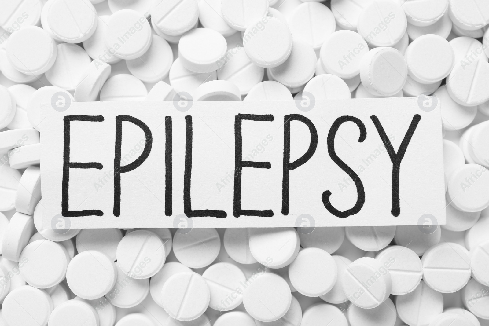 Photo of Card with word Epilepsy on pills, top view