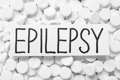 Photo of Card with word Epilepsy on pills, top view