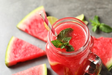 Photo of Summer watermelon drink with mint in mason jar on table, closeup