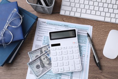 Photo of Tax accounting. Flat lay composition with calculator and document on wooden table