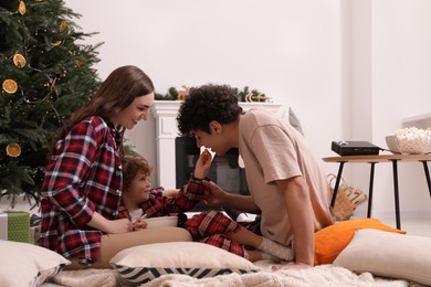 Family spending time together at home. Watching movie via video projector