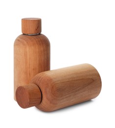 Photo of New stylish wooden bottles isolated on white