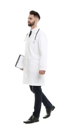 Photo of Young male doctor in uniform with clipboard isolated on white