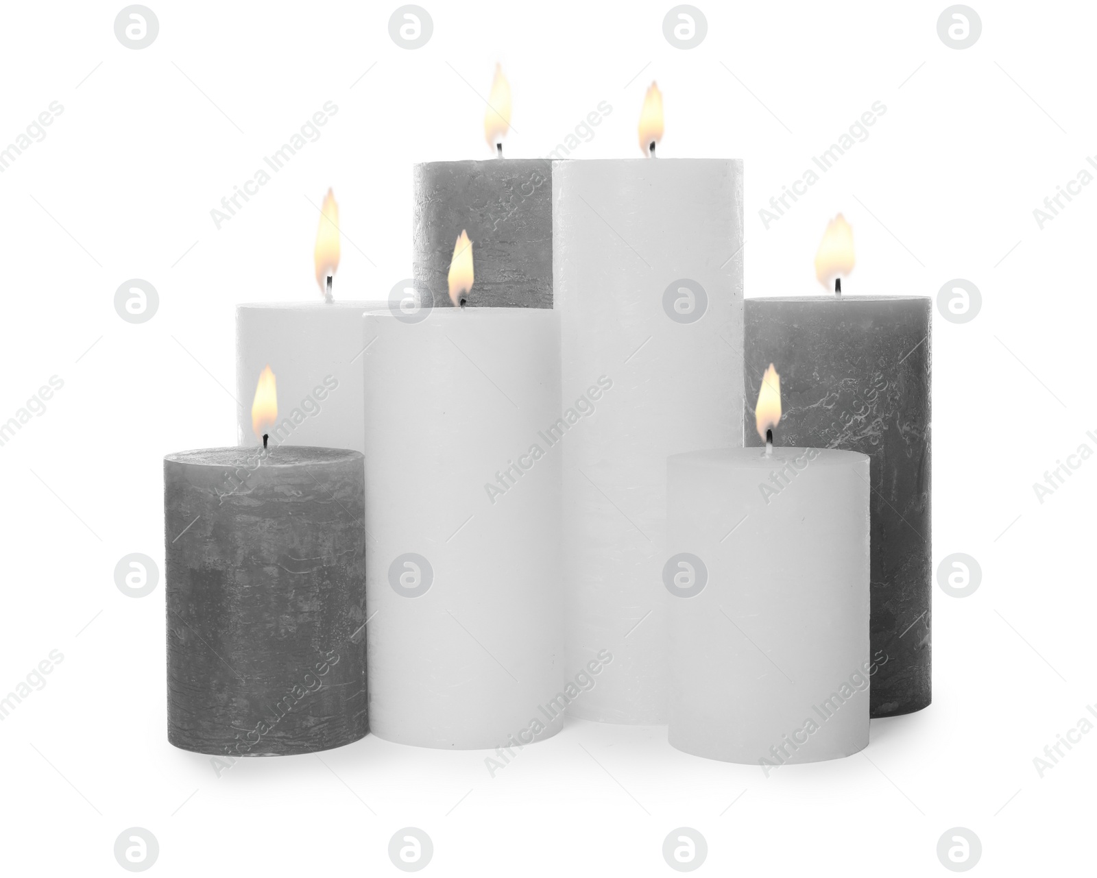 Photo of Many alight wax candles on white background