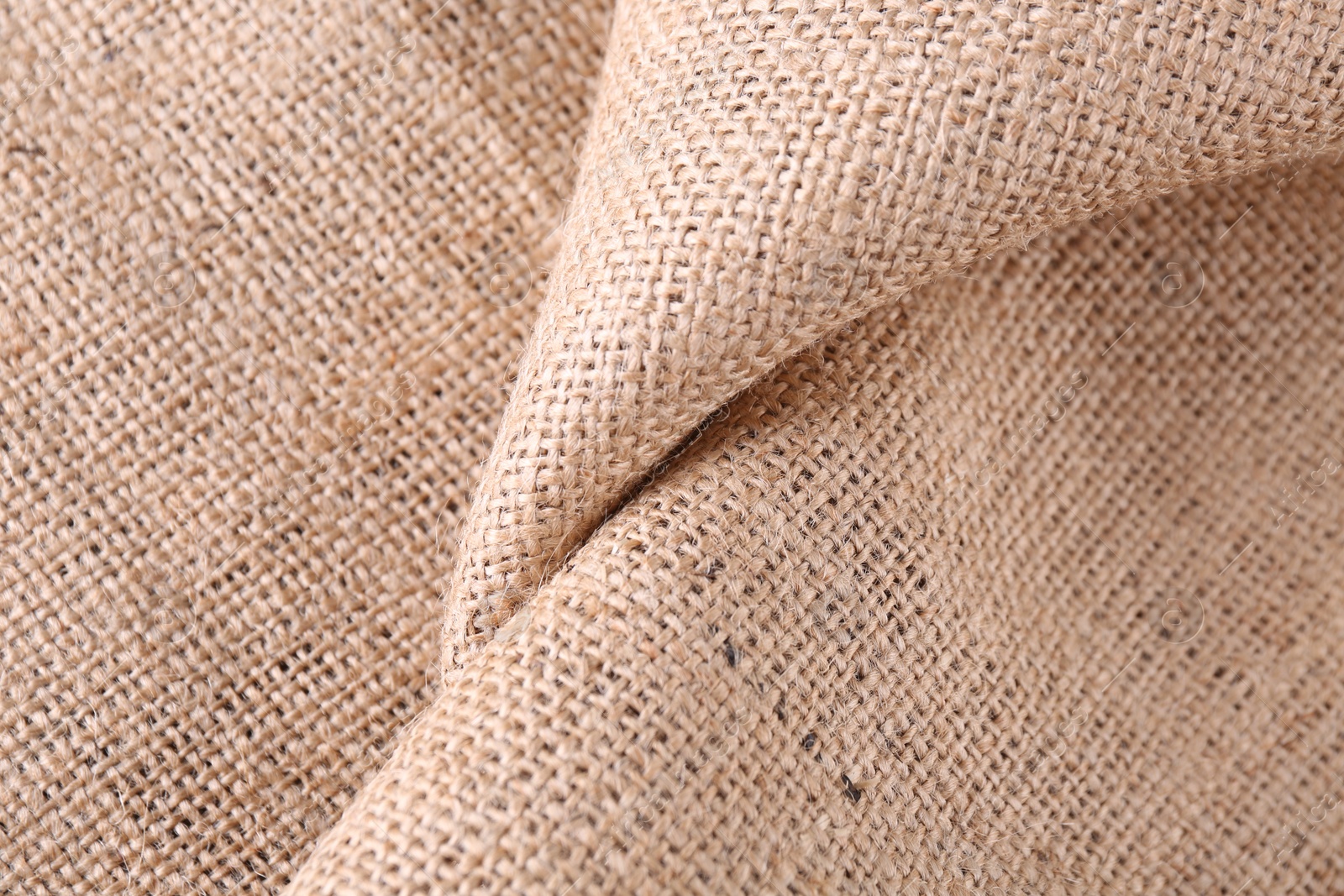Photo of Texture of beige burlap fabric, top view