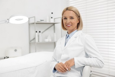 Photo of Portrait of happy dermatologist in modern clinic