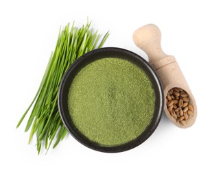 Wheat grass powder in bowl, scoop of seeds and fresh sprouts isolated on white, top view