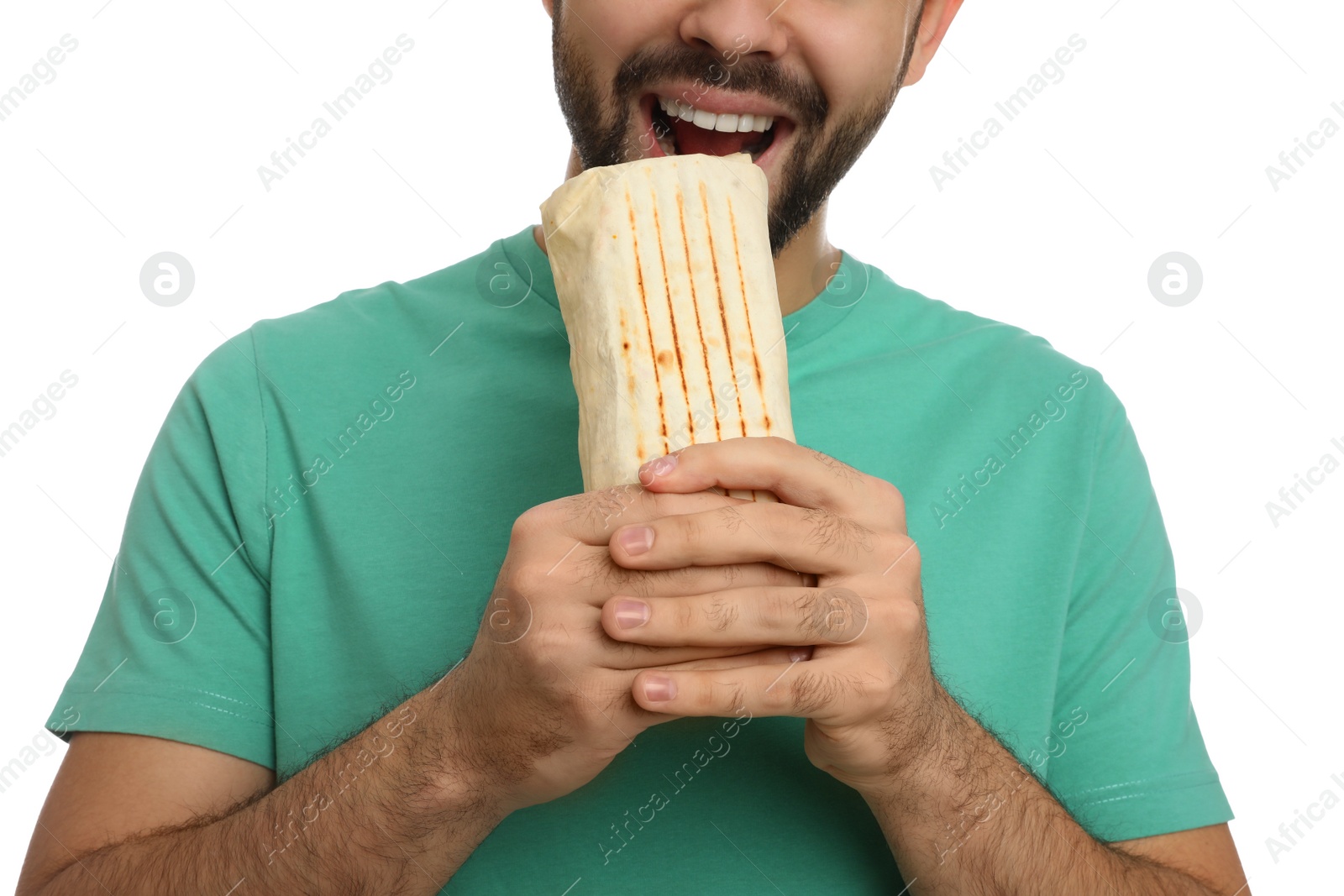 Photo of Young man eating tasty shawarma isolated on white, closeup