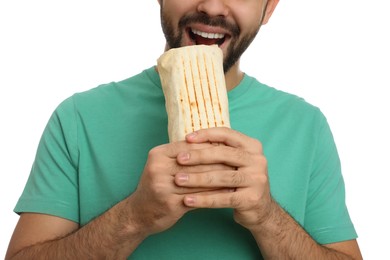 Young man eating tasty shawarma isolated on white, closeup