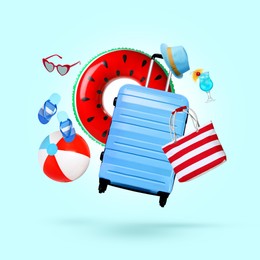 Image of Suitcase, cocktail and beach accessories flying on light blue background