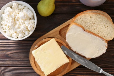 Photo of Tasty homemade butter, bread slices and tea on wooden table, flat lay