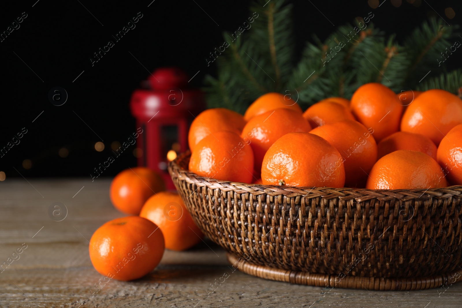 Photo of Ripe tangerines on wooden table against dark background. Christmas celebration