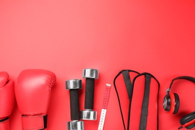 Photo of Flat lay composition with dumbbells on red background, space for text