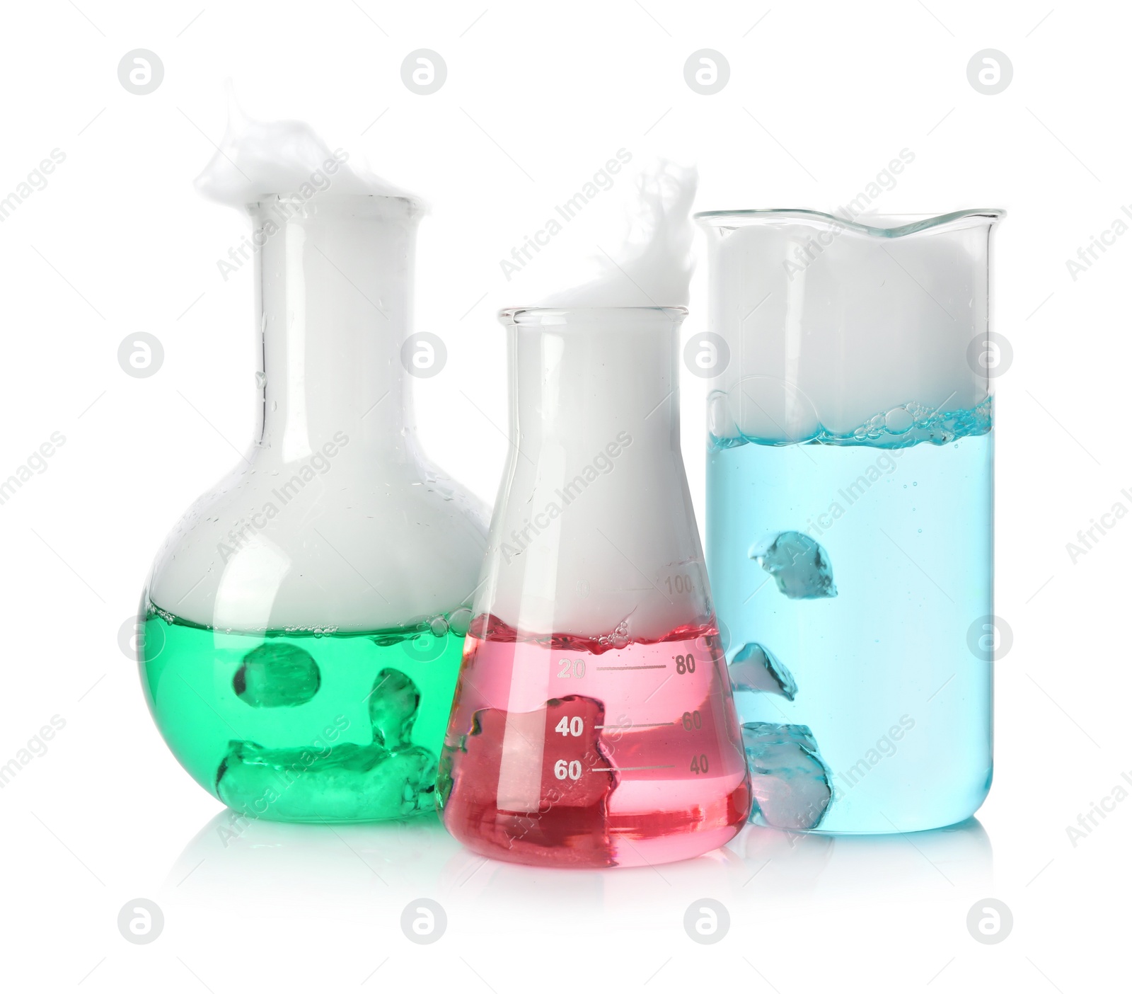 Photo of Laboratory glassware with colorful liquids and steam isolated on white. Chemical reaction