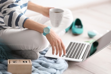 Photo of Female blogger with laptop and cup of coffee indoors