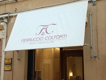 Photo of JESI, ITALY - MAY 17, 2022: Entrance of home decor store with canopy on city street