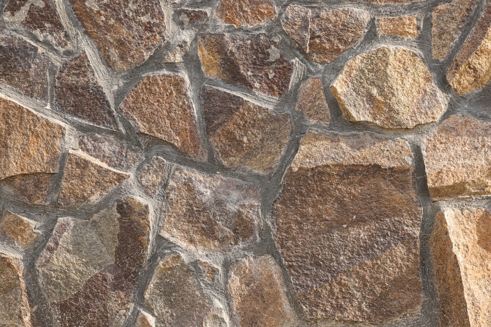 Photo of Texture of brown stone wall as background