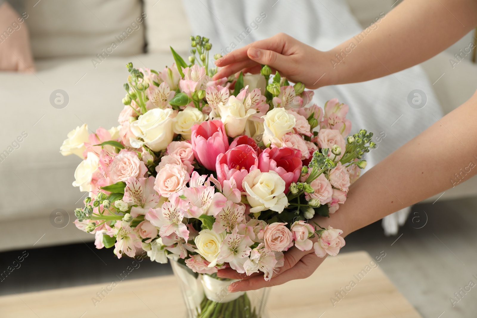 Photo of Woman with beautiful bouquet of fresh flowers at home, closeup