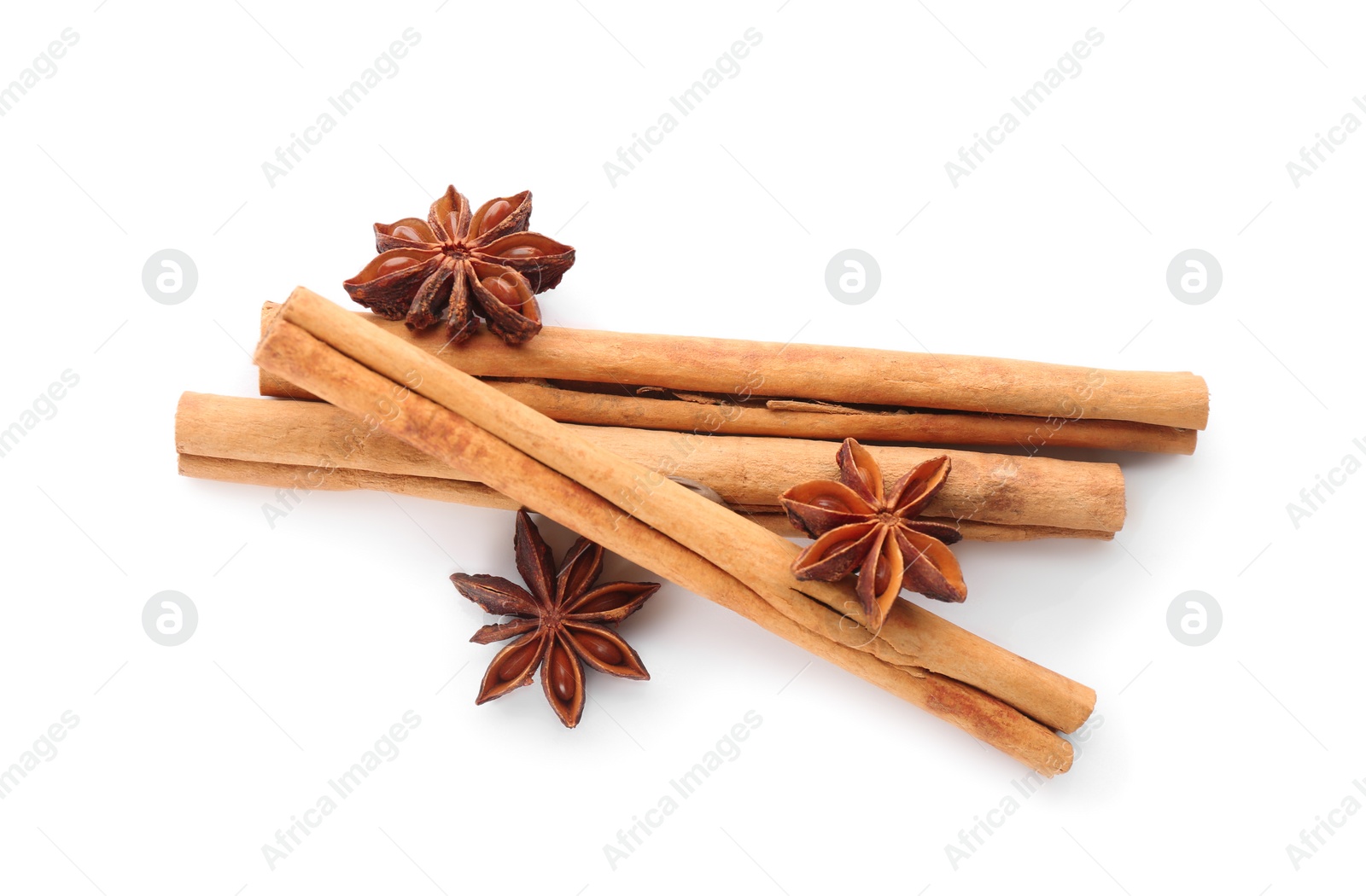 Photo of Aromatic cinnamon sticks and anise isolated on white, top view