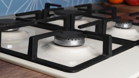 Photo of Modern gas cooktop in kitchen, closeup. Cooking appliance