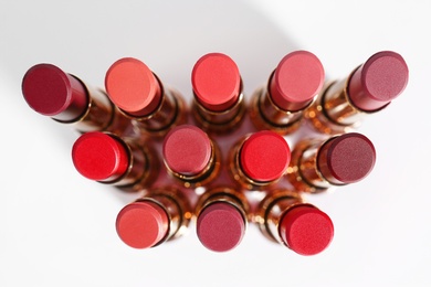 Set of bright lipsticks on white background, flat lay