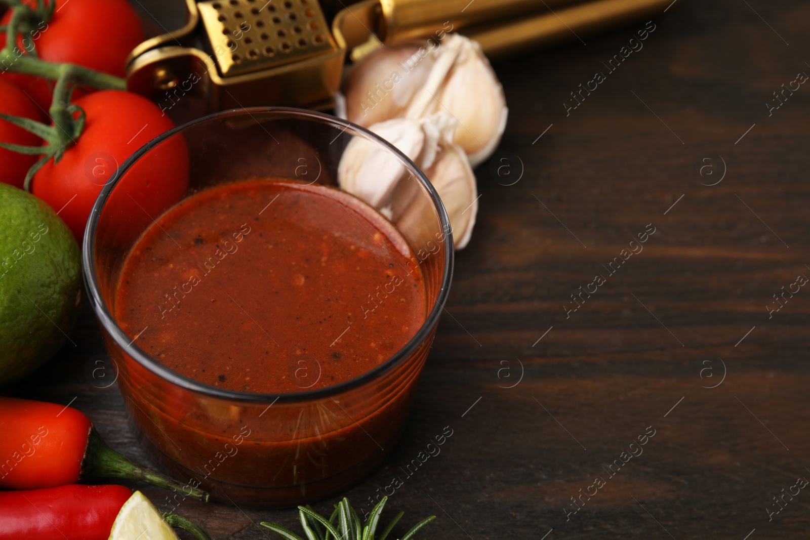 Photo of Tasty marinade and products on wooden table, closeup. Space for text