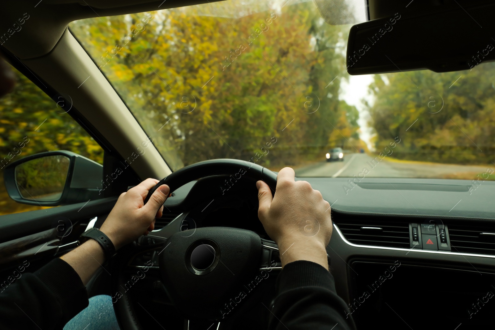 Photo of Man driving his car, closeup. Traffic rules