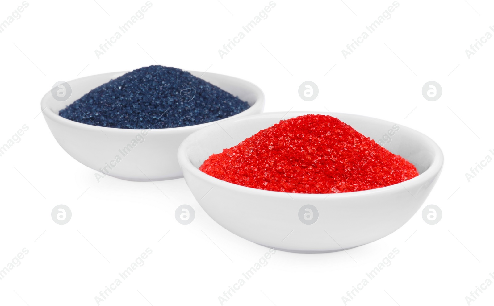 Photo of Bowls with food coloring on white background