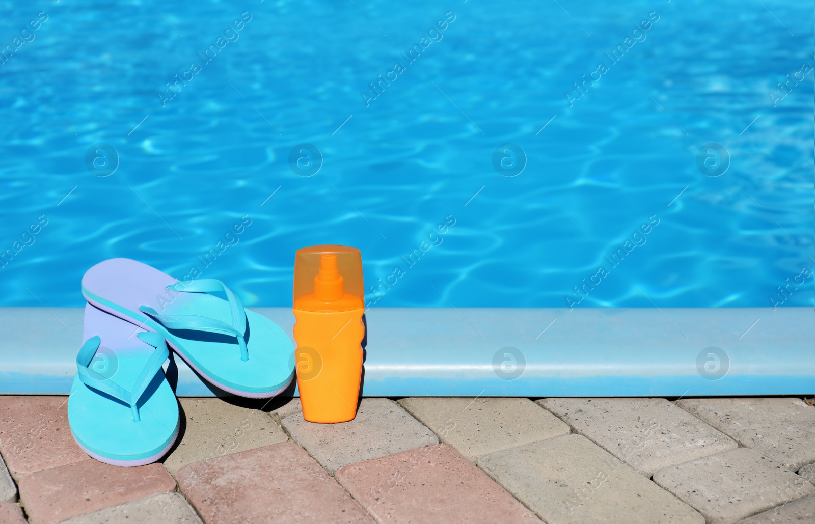 Photo of Beach accessories near swimming pool on sunny day. Space for text