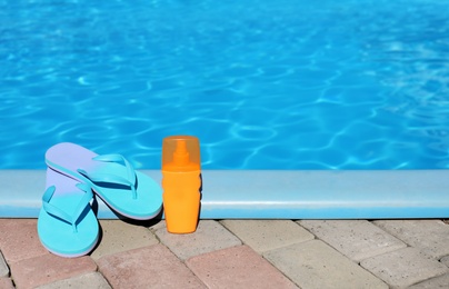 Beach accessories near swimming pool on sunny day. Space for text