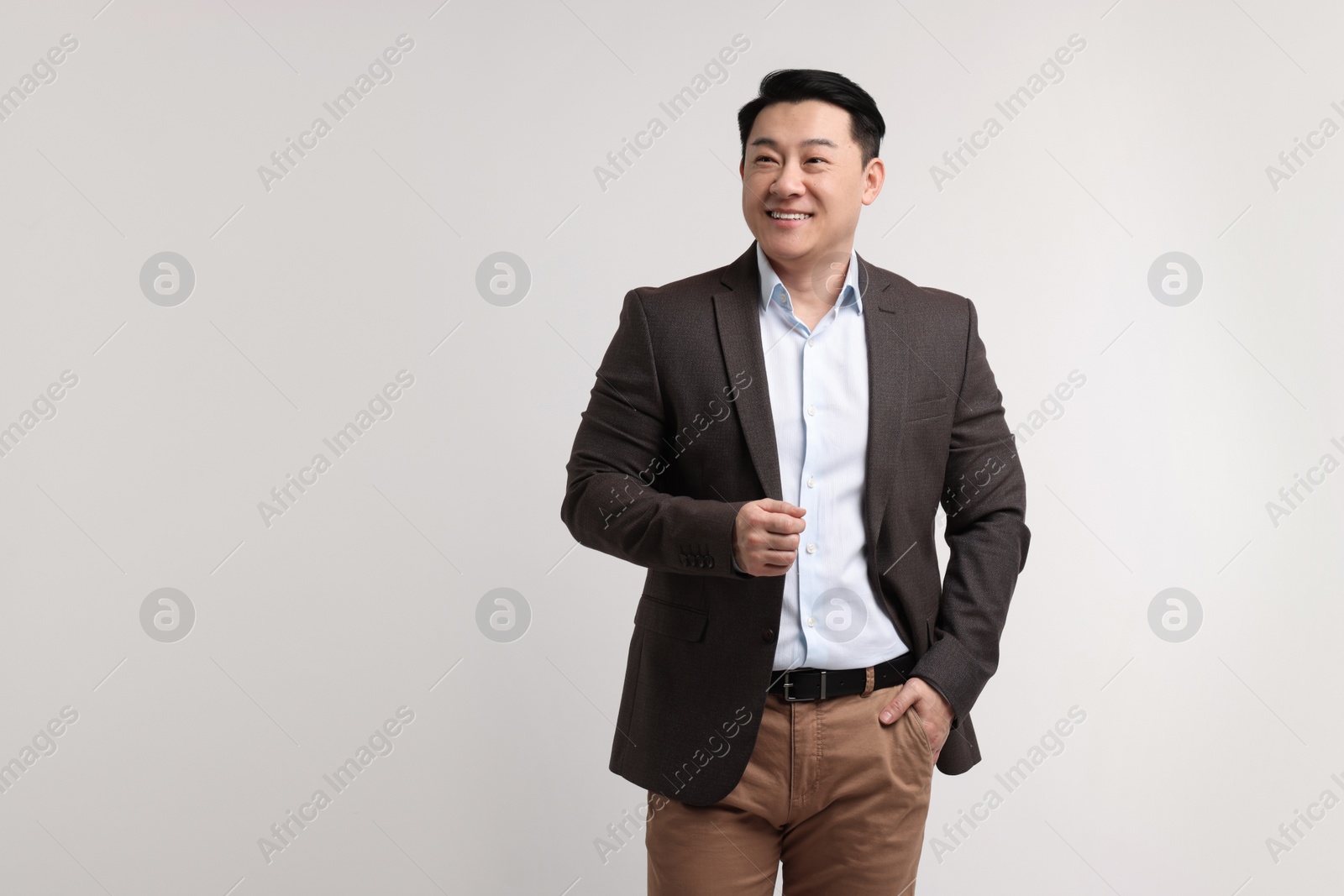 Photo of Portrait of happy man on light background. Space for text