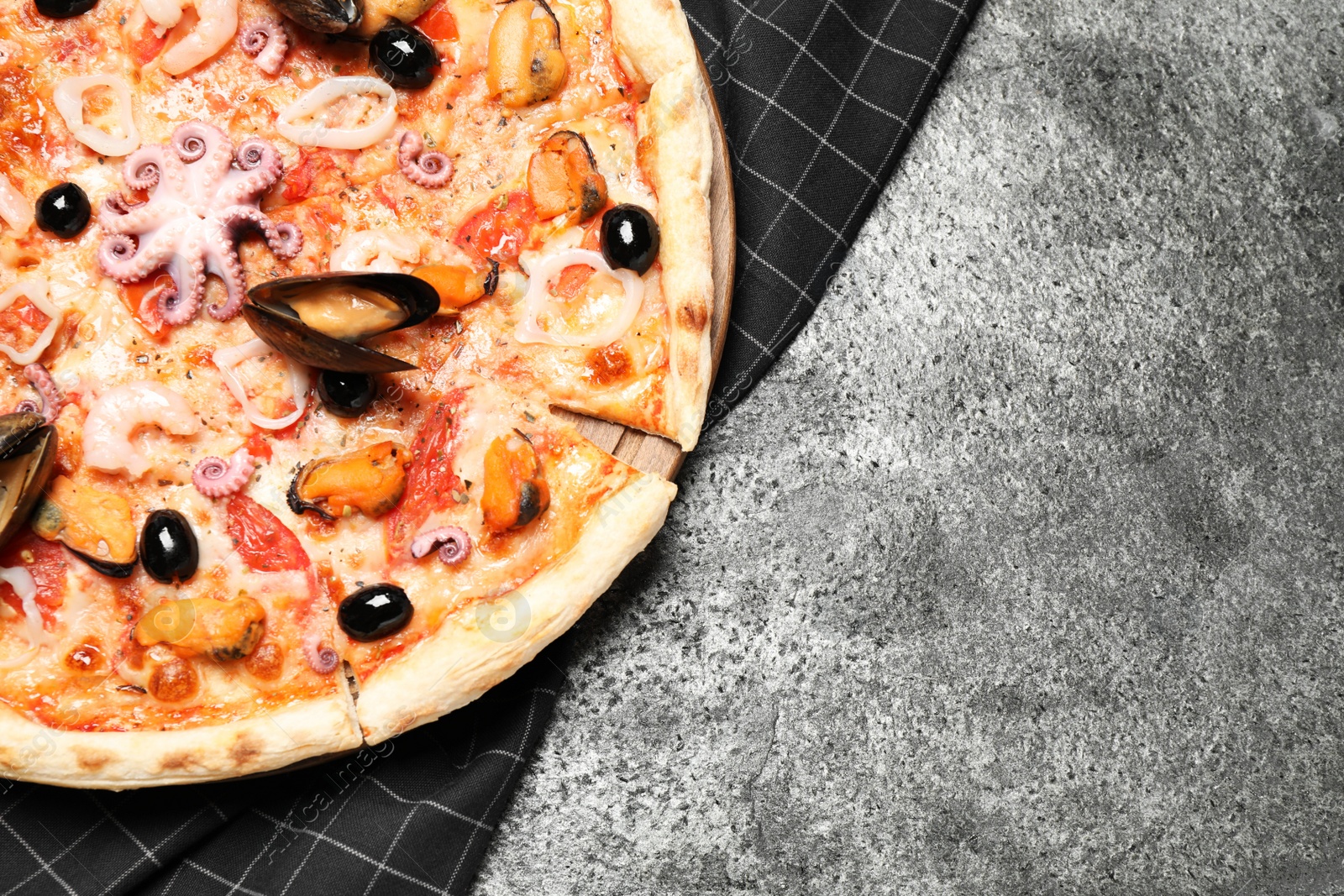 Photo of Tasty pizza with seafood on grey table, top view. Space for text