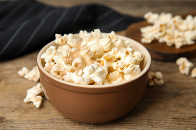 Tasty pop corn on wooden table, closeup