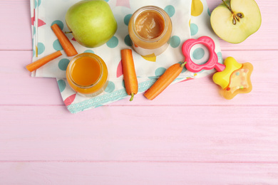 Photo of Healthy baby food in jars and fresh ingredients on pink wooden table, flat lay. Space for text