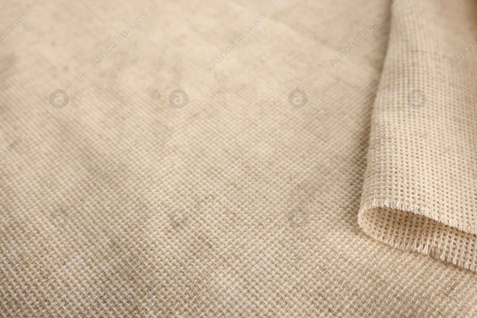 Photo of Texture of natural burlap fabric as background, closeup