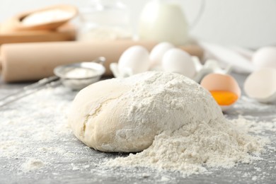 Wheat dough and products on grey table. Cooking pastries