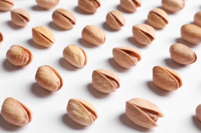 Photo of Organic pistachio nuts in shell on white background