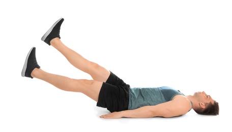 Photo of Young man doing scissors exercise on white background