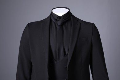 Photo of Male mannequin dressed in stylish black suit on grey background