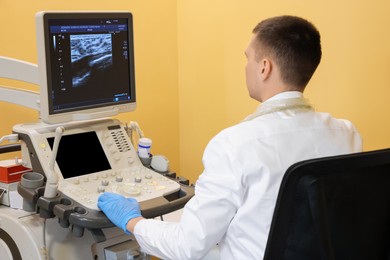 Photo of Mammologist working with ultrasound machine in clinic