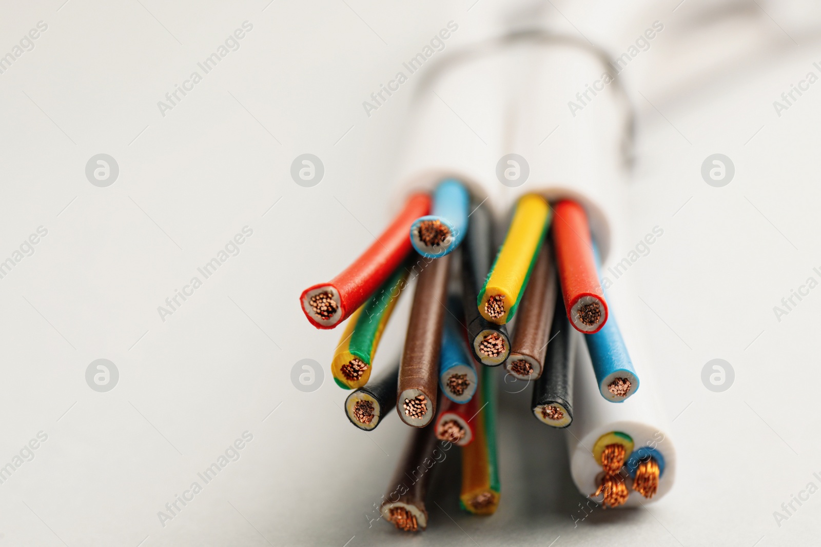 Photo of Cables with wires on light background, closeup