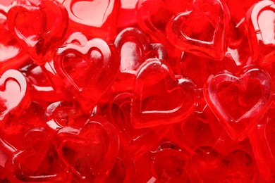 Photo of Many red heart shaped jelly candies as background, closeup