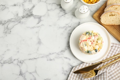 Photo of Delicious salad with fresh crab sticks served on marble table, flat lay. Space for text