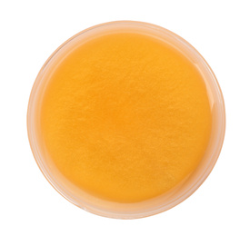 Photo of Orange slime in plastic container isolated on white, top view. Antistress toy